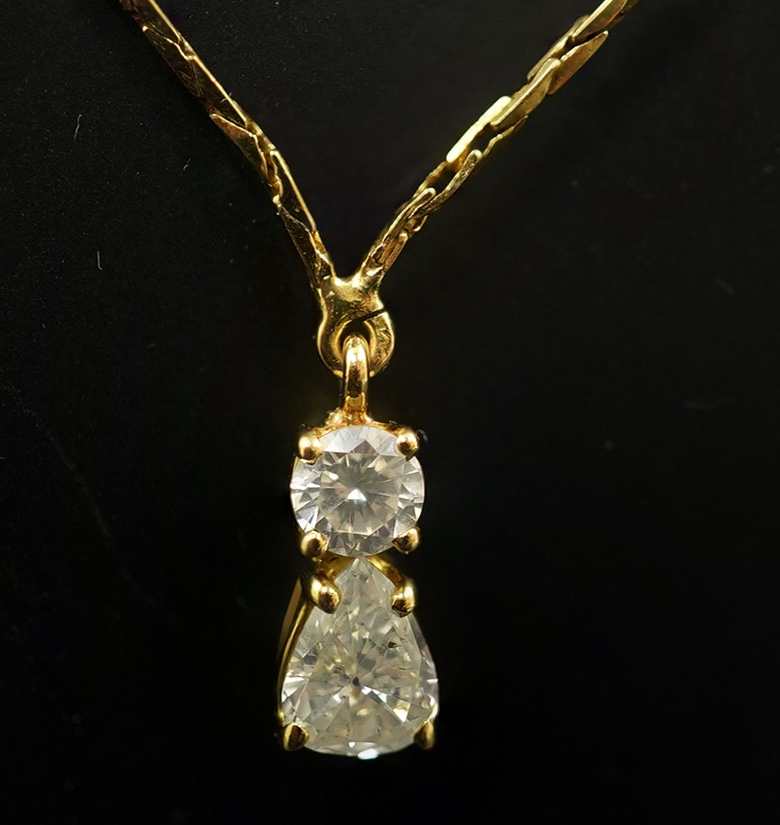 A modern gold and two stone diamond pendant